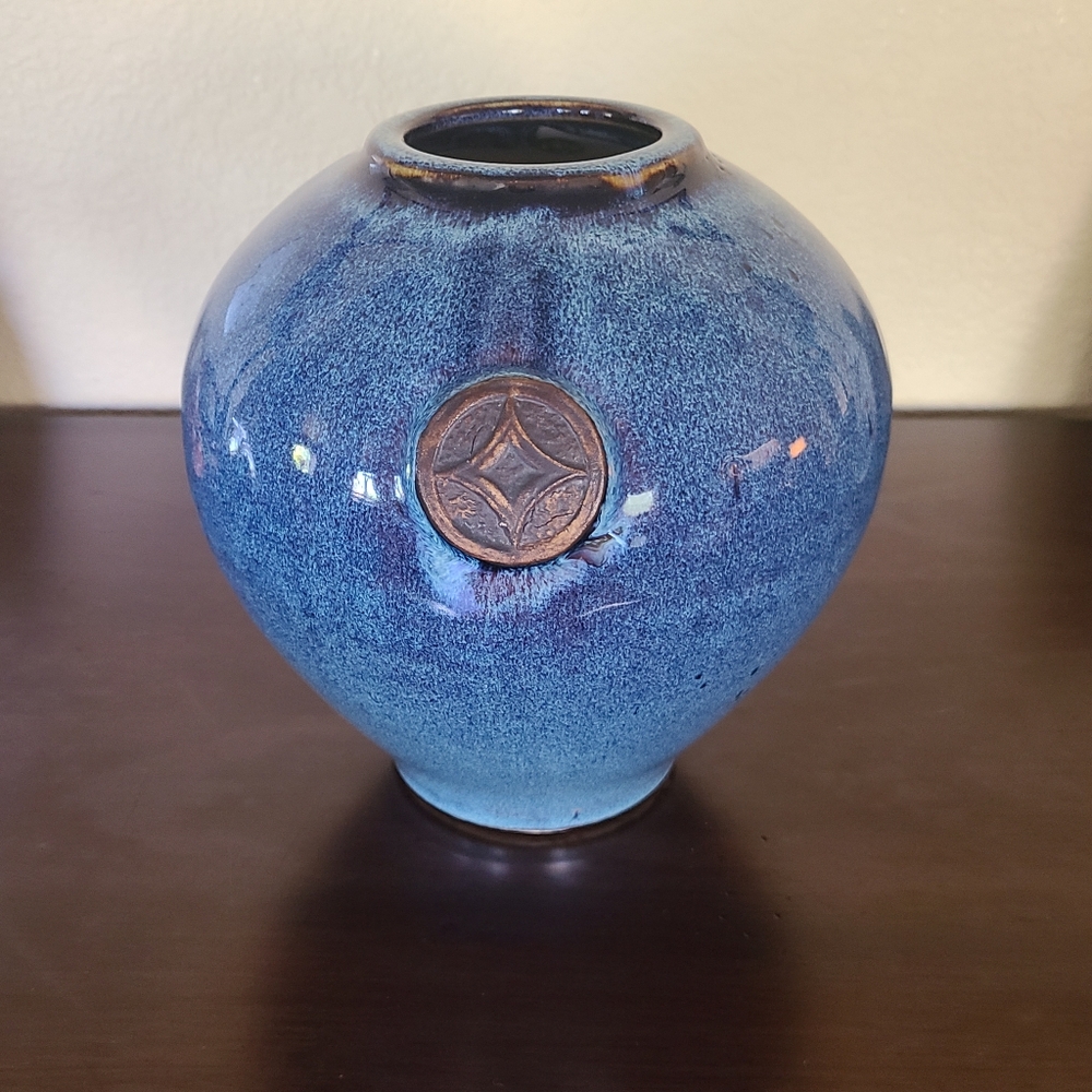 Beautiful blue glazed pottery piece with medallions on front back.